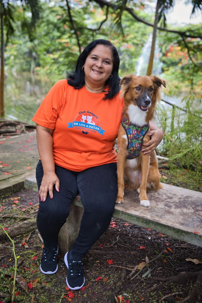 Presidenta del Club Amigos de los 4 Patas sonriendo junto a un perrito rescatado